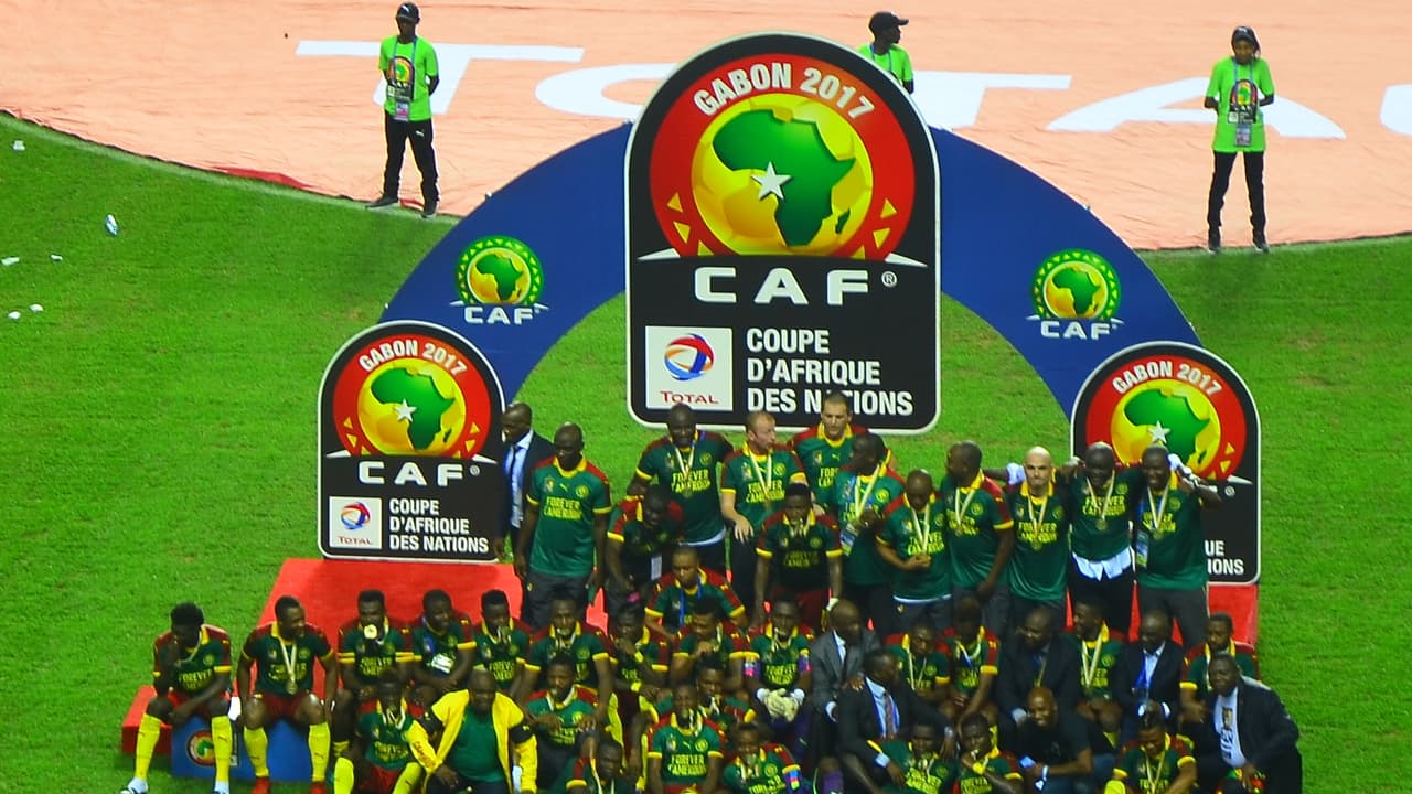 Des joueurs camerounais célèbrent leur victoire à la Coupe d'Afrique des nations, le trophée levé.